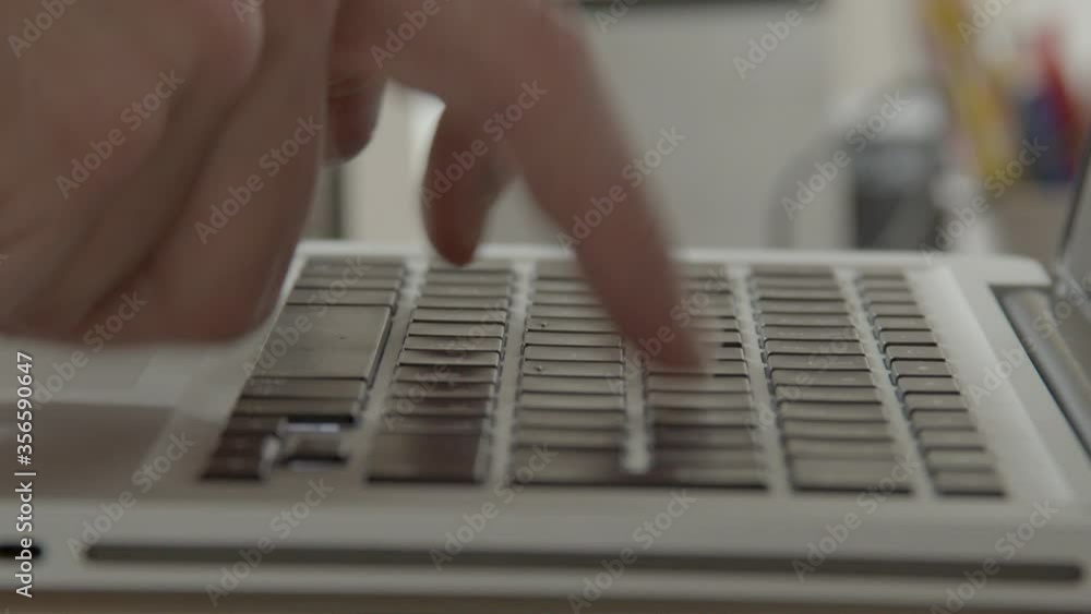 Poster hands quickly typing on laptop with index fingers only