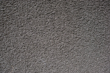 Gray doormat which is made from synthetic fibers.