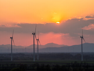Obraz premium Windmill turbine for power generator at sunset