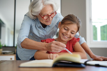 grandmother helping grandkid with homework