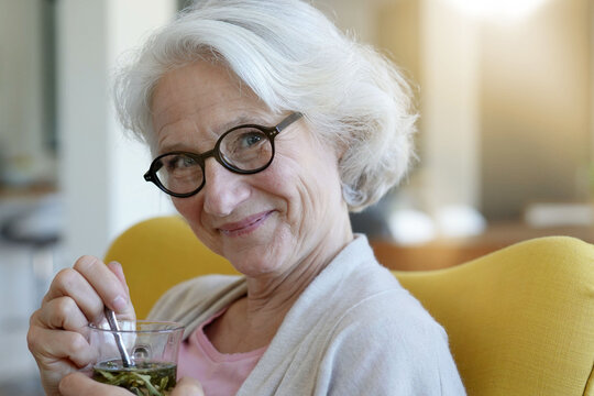 Portrait Of Senior Woman Drinking Herbal Tea