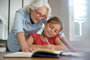 grandmother helping grandkid with homework