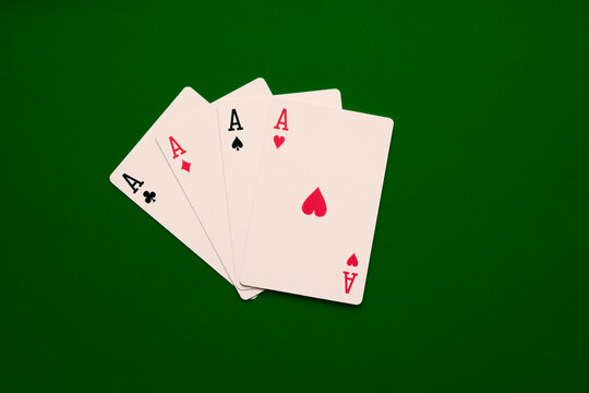 Four aces poker cards close up on green backgorund. Four of a kind conbination in pocker game. Poker  combinations concept.