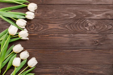 Spring white tulips on wooden background