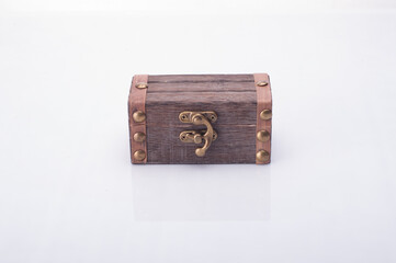 A miniature treasure chest isolated over white