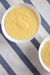 Homemade vanilla custard pudding on cloth, view from above. Overhead, flat lay, top view.