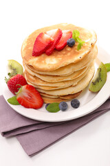 stack of pancakes with fresh fruits