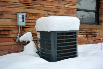 Snow Covered Air Conditioner on a Cold Winter Day