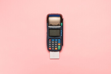 NFC payment contactless terminal on a pink background. Credit card or phone pay pos banking device,...