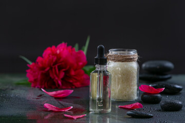 composition with cosmetic Spa products, with red peonies on a black background
