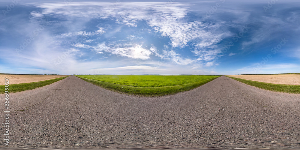 Wall mural Full spherical seamless panorama 360 degrees angle view on no traffic asphalt road among fields with cloudy sky in equirectangular projection, VR AR content