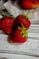 fresh strawberries on a light background with daisies