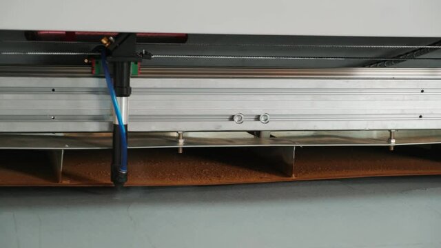 CNC machine for cutting fabrics textile materials and leather, laser marking and measurement. Modern footwear production. 