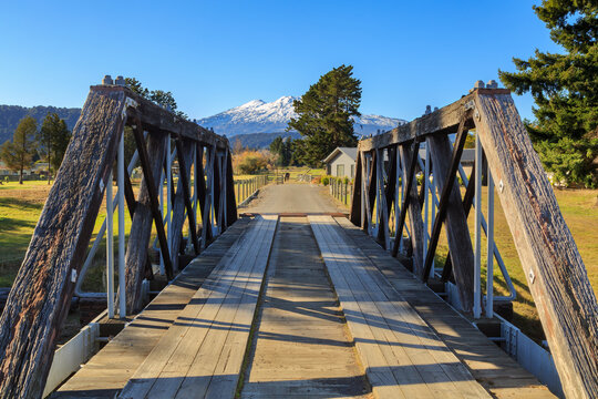 A historic (unused) rail bridge in Ohakune, New Zealand, with Mount Ruapehu on the horizon