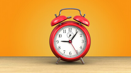 retro red alarm clock at 9 o' clock on orange background.