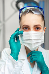 Personal protective equipment, woman doctor in personal protective equipment on the background of a...