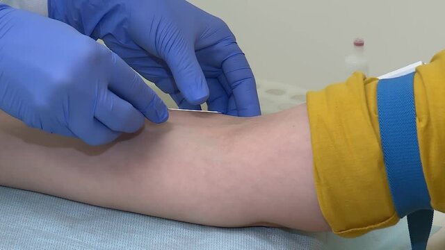 closeup, stick a needle in a vein for blood sampling from a vein