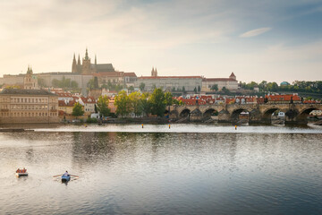 Naklejka premium Evening view on Prague Castle with Charles Bridge in evening sunlight