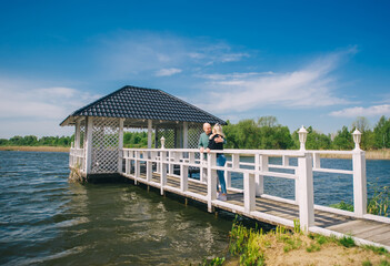 Happy loving couple rest on lake