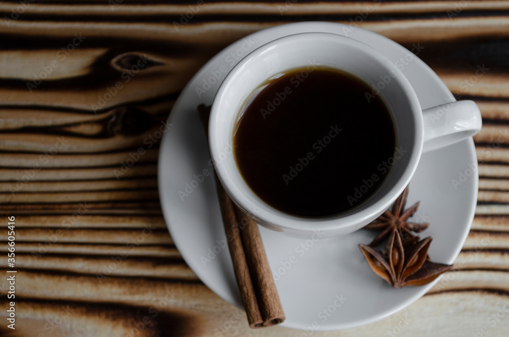 Wall mural espresso on wooden background with star anise and cinnamon