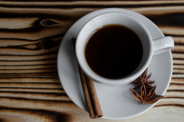 espresso on wooden background with star anise and cinnamon