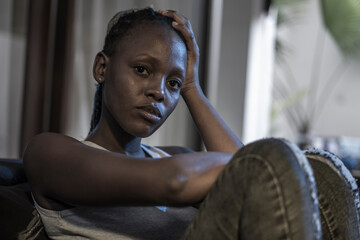 Millennial generation African American girl at night suffering depression - young attractive sad...