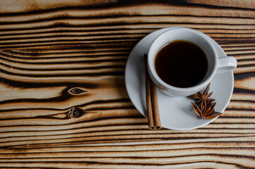 espresso on wooden background with star anise and cinnamon