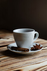 espresso on wooden background with star anise and cinnamon