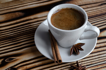 espresso on wooden background with star anise and cinnamon