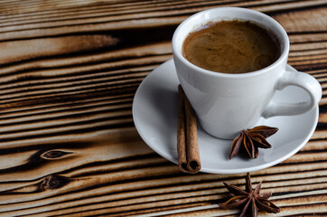 espresso on wooden background with star anise and cinnamon
