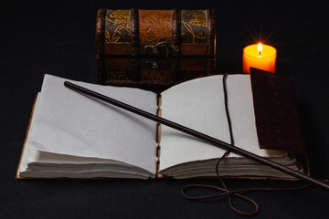 Image of open magic book on the table in the dark room.