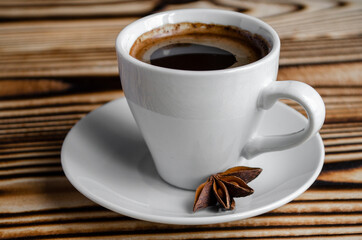 espresso on wooden background with star anise and cinnamon
