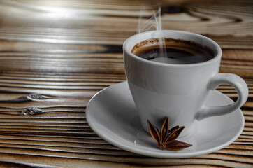 espresso on wooden background with star anise and cinnamon