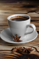 espresso on wooden background with star anise and cinnamon