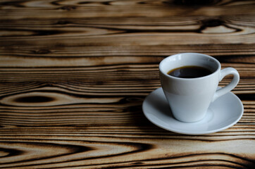 espresso on wooden background with star anise and cinnamon