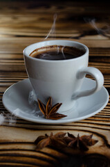 espresso on wooden background with star anise and cinnamon