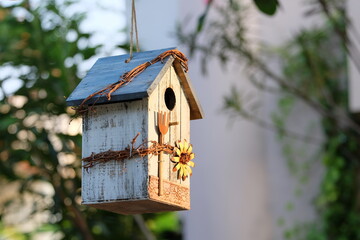 A bird house decorated in a garden makes our backyard beautiful. And there are birds creating a fresh atmosphere in the backyard.
