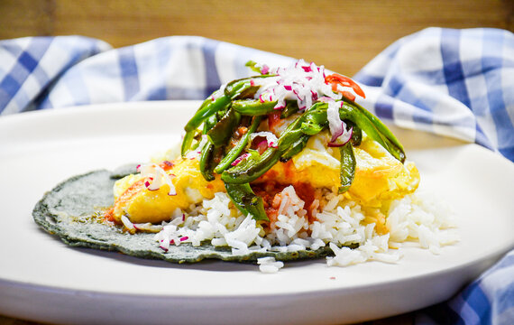 Taco de arroz con huevo y chile sobre tortilla de ma&iacute;z azul