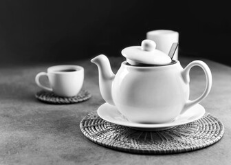 White porcelain tea cup and teapot, Afternoon tea table setting Black & White.