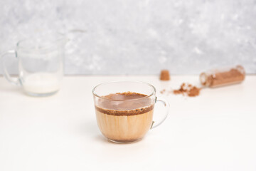 Dalgona cocoa coffee with ice and creamy whipped instant coffee on wooden tray. Trend korean drink latte on marble table