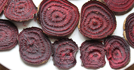 baked beetroot slices on a white plate close up