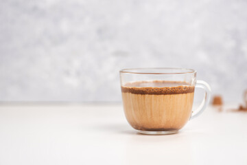 Dalgona cocoa coffee with ice and creamy whipped instant coffee on wooden tray. Trend korean drink latte on marble table