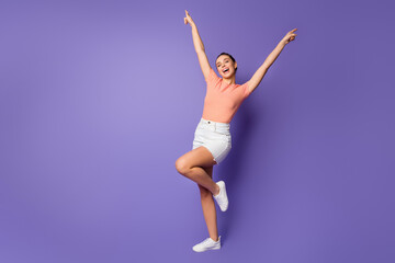 Fototapeta na wymiar Full length photo positive youngster girl enjoy spring free time weekend imagine she dance discotheque floor raise hands close eyes wear good look clothes isolated violet color background
