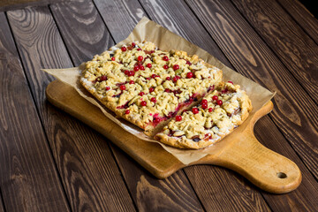 sliced ​​homemade grated pie with berries