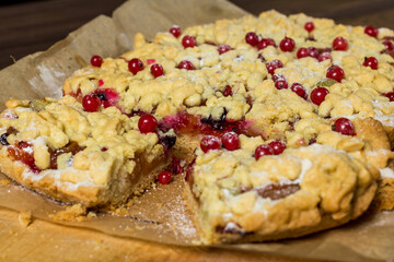 sliced ​​homemade grated pie with berries