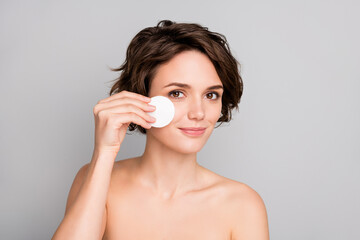 Closeup photo of beautiful charming naked lady short bob hairdo hold cotton disk pad removing makeup facial skin enjoy micellar water effect isolated grey color background © deagreez