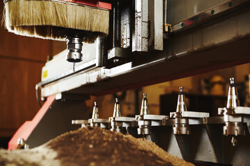 Machine with numerical control for cutting wood with various router bits.