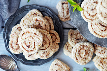 Cinnamon cookies on a rustic plate on a light wooden background