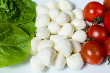 Italy flag made from lettuce, mozzarella cheese and cherry tomatoes.
