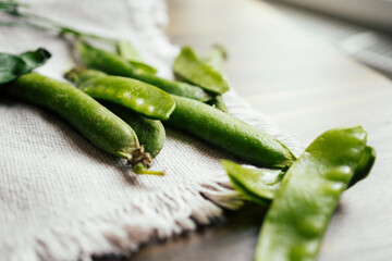 Pellets of green peas on wooden background